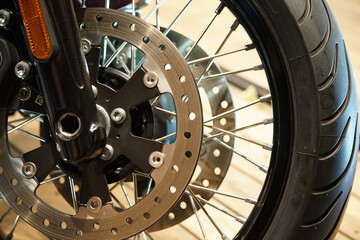 Parts of the front wheel and disc break of a motorcycle ride