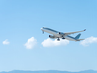 Commercial aircraft taking off on a sunny day.