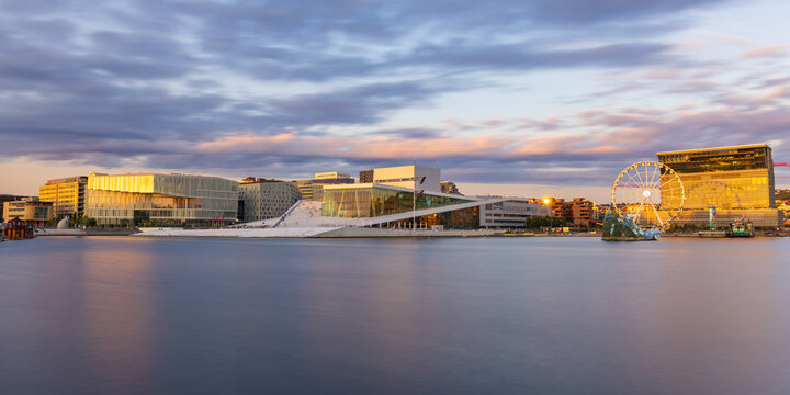 Oslo, Norway - August 2, 2024: Long exposure shot before sunset of the Oslo Opera House and the Munch museum along the Oslo Fjord in the Bj&oslash;rvika area of the center of Oslo