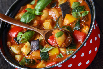 hearty italian vegetable stew in red pot, top view
