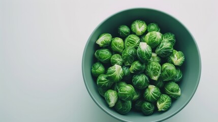 A bowl of fresh, bright green Brussels sprouts, illustrating healthy eating and vibrant vegetable imagery.