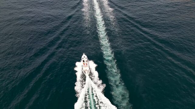 Aerial view of beautiful boats creating wakes on the blue sea, Puerto de Andratx, Mallorca, Spain.