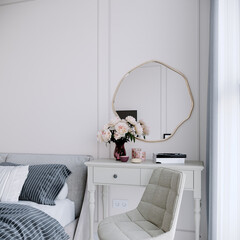 Render of bedroom vanity corner with organic circle shaped mirror, beige vanity desk and beige armchair.
