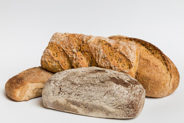 Homemade natural breads. Different kinds of fresh bread as background, perspective view with copy space