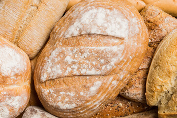 Homemade natural breads. Different kinds of fresh bread as background, top view with copy space