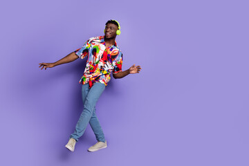 Full size photo of nice young man dancing empty space wear shirt isolated on violet color background