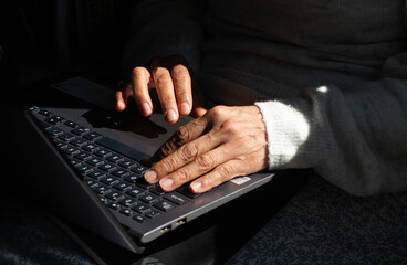 a woman's hands on a laptop