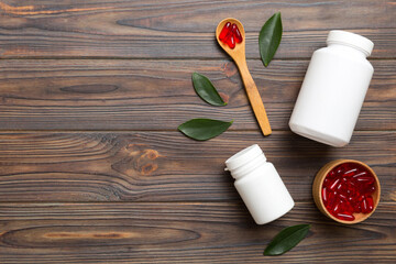 different drugs and health supplement pills with medicine bottle health care and medical top view. Vitamin tablets. Bottle with colored pills on table background. Multivitamins