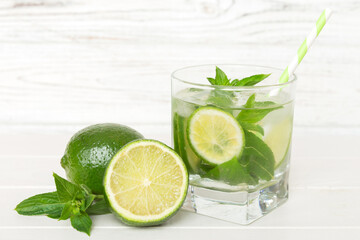 Mojito cocktail. Refreshing mojito cocktail with lime, lemon and mint in a tall glass with a stick