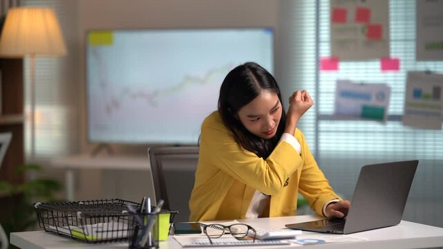 Asian businesses women working in the office used laptop and smartphone at her dest 