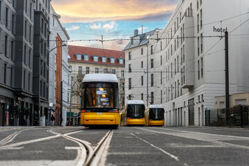 Scenic evening view many modern yellow tram car parked at street station Berlin Mitte central district at dusk warm sunset. Urban european transport commute cityscape Germany scene background © Kyryl Gorlov