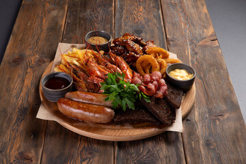 Assorted snacks for beer on a wooden background. selective focus.