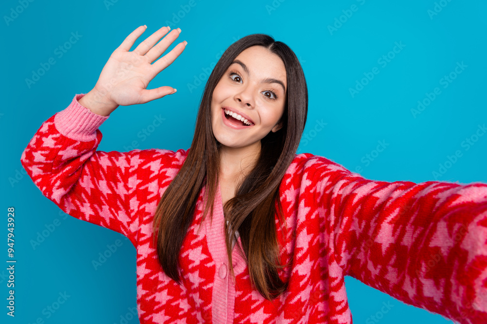 Sticker Photo of optimistic woman with straight hairstyle dressed knitwear cardigan making selfie give highfive isolated on blue color background