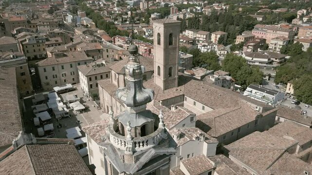 Aerial drone footage of Jesi, a charming Italian town with a well-preserved medieval borough, featuring narrow cobblestone streets, historic buildings, and the picturesque surrounding landscape