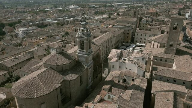 Aerial drone footage of Jesi, a charming Italian town with a well-preserved medieval borough, featuring narrow cobblestone streets, historic buildings, and the picturesque surrounding landscape