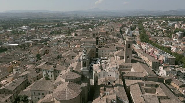 Aerial drone footage of Jesi, a charming Italian town with a well-preserved medieval borough, featuring narrow cobblestone streets, historic buildings, and the picturesque surrounding landscape