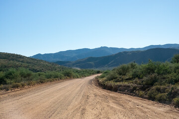 Dirt road trails off into a mountainous background