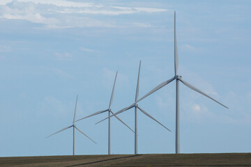 Fototapeta premium Symmetry in a row of turbines on a wind farm