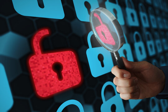 Security engineer identifying information security vulnerability in internet network system. Unlocked padlock icon and many other locked padlock icons. Hand holding magnifying glass.