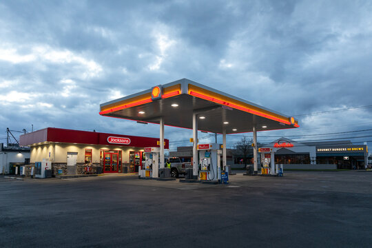 Beaverton, Oregon, USA-March 29, 2022- American famous Shell gas station high quality picture with its big orange shell logo on it, illuminated at night