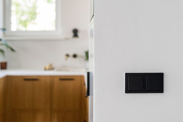 Modern kitchen interior featuring elegant light switches on a white wall