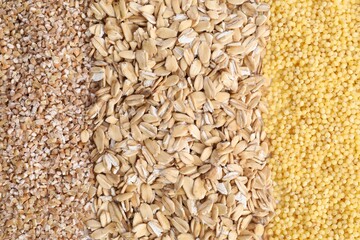 Oat flakes, wheat and millet groats as background, top view