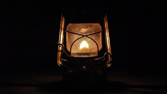 A close-up shot of a kerosene lantern with a black background.