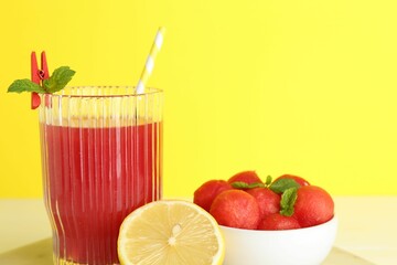 Tasty watermelon drink in glass and fresh fruits on table, closeup