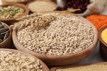 Obraz premium Different types of cereals, legumes and seeds on table, closeup