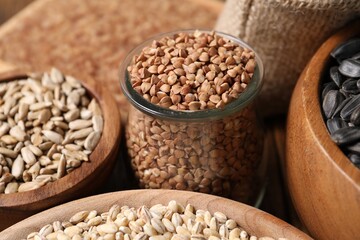 Obraz premium Different types of cereals and seeds on table, closeup