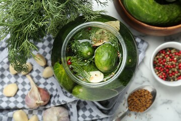 Making pickles. Fresh cucumbers and spices in jar on table, top view