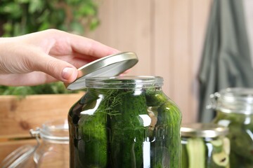 Woman making pickled cucumbers at table, closeup - Powered by Adobe