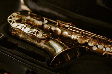 High angle medium closeup of saxophone in black colored case