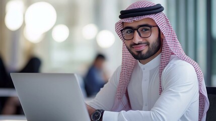 Saudi businessman working on a laptop