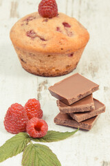 Fresh baked muffin with raspberries and chocolate. Delicious dessert for different occasion