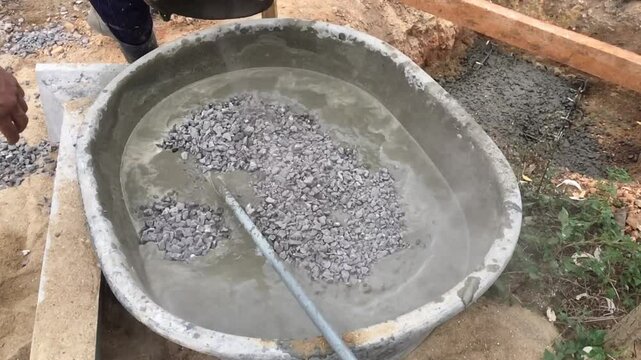 Mixing together to make a strong concrete floor, Mixing concrete concept, Slow motion