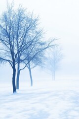 Tranquil winter scene of bare trees in a snow-covered landscape, wrapped in a serene, misty atmosphere.