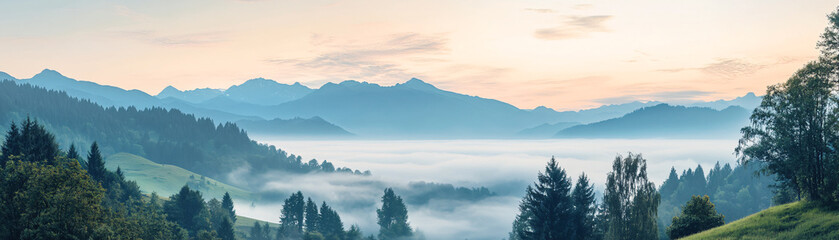Obraz premium A foggy mountain landscape with a blue sky. The mountains are covered in trees and the sky is a mix of blue and pink