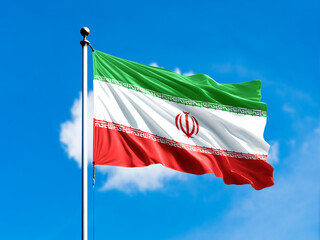 Iran flag flying on blur blue clouds background.