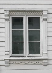 Fototapeta premium Beautiful old window of a white timber house in Stavanger, Norway.