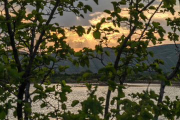 Fototapeta premium Sunset view by the lake in the evening. Sunset over the lake in the evening. Sunset from the campsite in the evening.