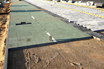 Sidewalk Tiles Laying on street in city. Laying Paving Slabs on construction site. Stone paving slab on sidewalk. Sidewalk tile paving for footpath. Pedestrian road construction and renovation.