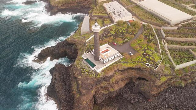 Aerial view of Faro de Punta Cumplida with banana trees and rocky cliffs by the Atlantic Ocean, Lomo Machin, Spain.