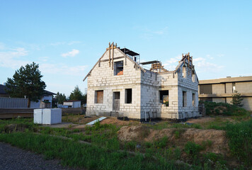 Suburb House construction. Country house, cottage, villa. Home outside city. Country house, green lawn. Family house in Suburb. Dream country home for family. Housing. Suburban Home Exterior, building