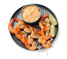 Skewers with delicious grilled shrimps, lime and sauce isolated on white, top view