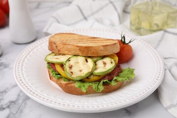 Tasty sandwich with grilled vegetables on white marble table, closeup