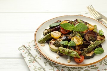 Delicious salad with grilled vegetables on white wooden table, closeup. Space for text