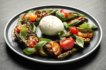 Tasty salad with grilled vegetables and mozzarella cheese on grey table, closeup