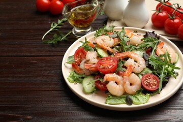 Delicious shrimp salad and ingredients on wooden table, closeup