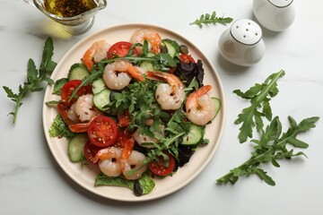 Delicious shrimp salad with vegetables served on white marble table, flat lay
